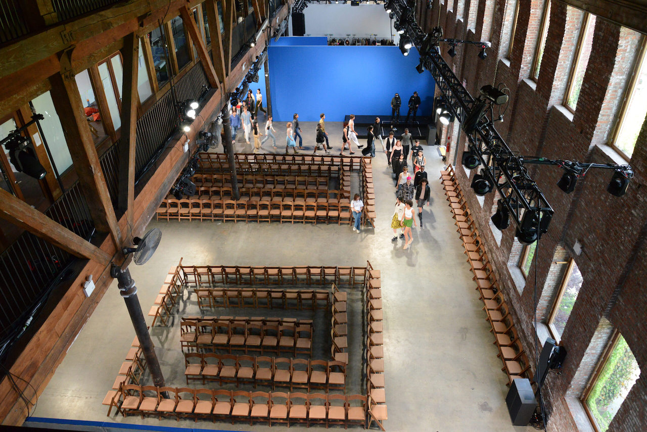 aerial shot, of a large hall, with seating configured as if in a fashion show
