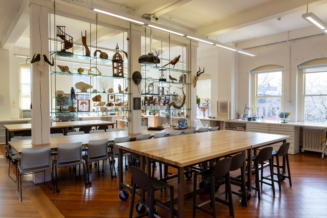 Photograph of the Foundations Lab showing large work tables and study models on shelves.