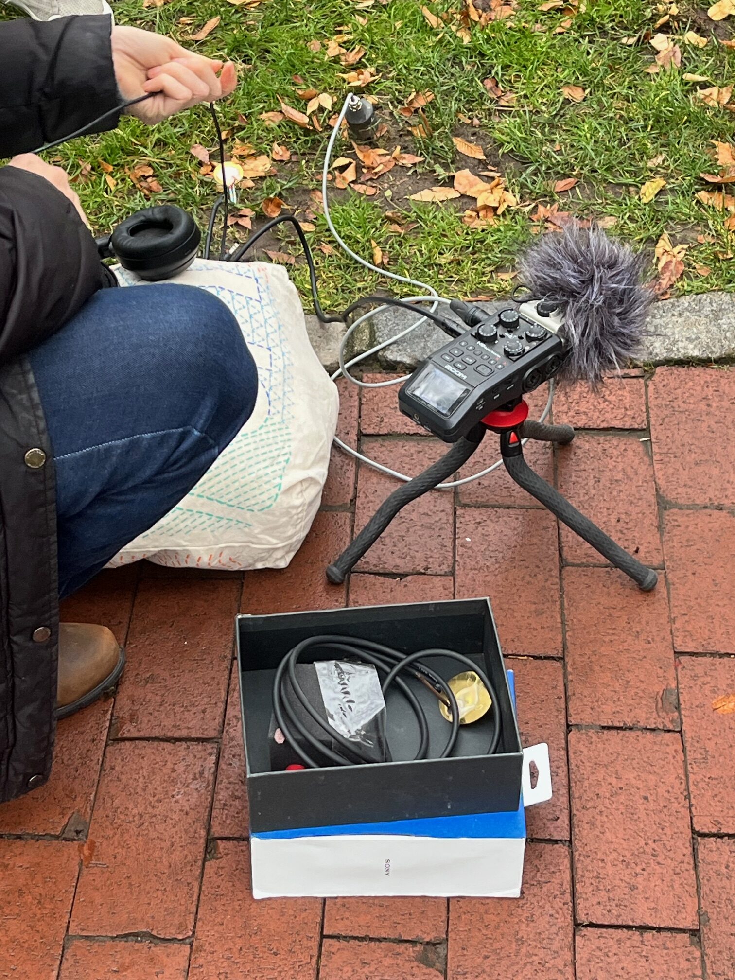 students making a sound recording on Pratt's campus using a professional microphone.