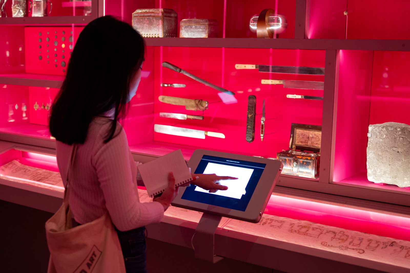 Woman, in historical museum, at information kiosk.