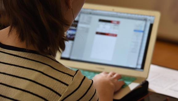 Student at laptop, conducting research