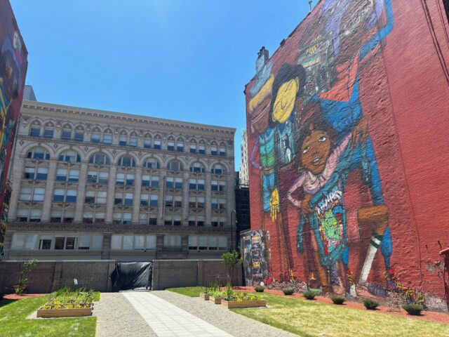 Dean Cocciolo and Associate Director Brull paid a visit to our neighbors to explore the option of using their backyard for a school event or two.  Interesting to see the OSGEMEOS mural from a different perspective!