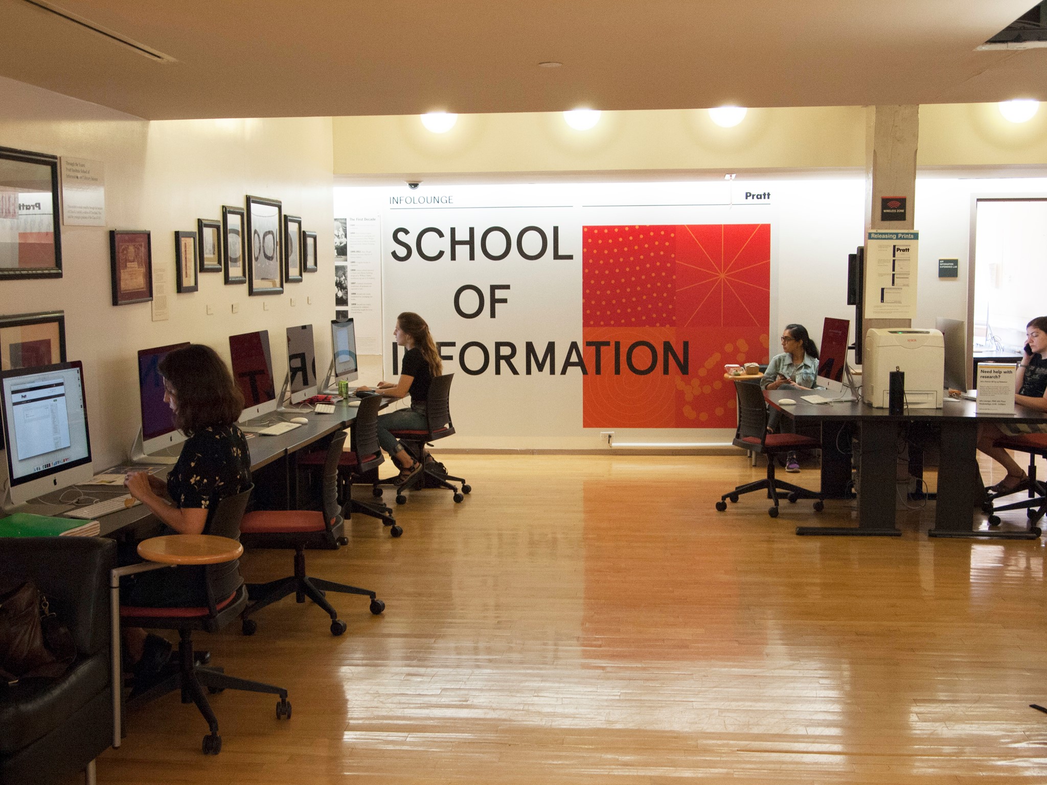Photo of the InfoLounge on the 6th floor. Shows a space with computer workstations so occupied by students.