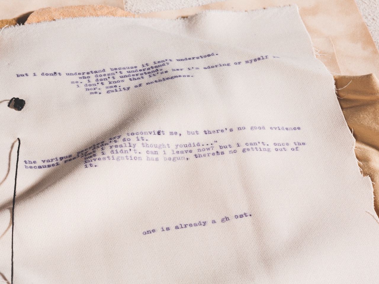 printed words on folded linen that resembles a piece of paper in a book by Daniel Terna