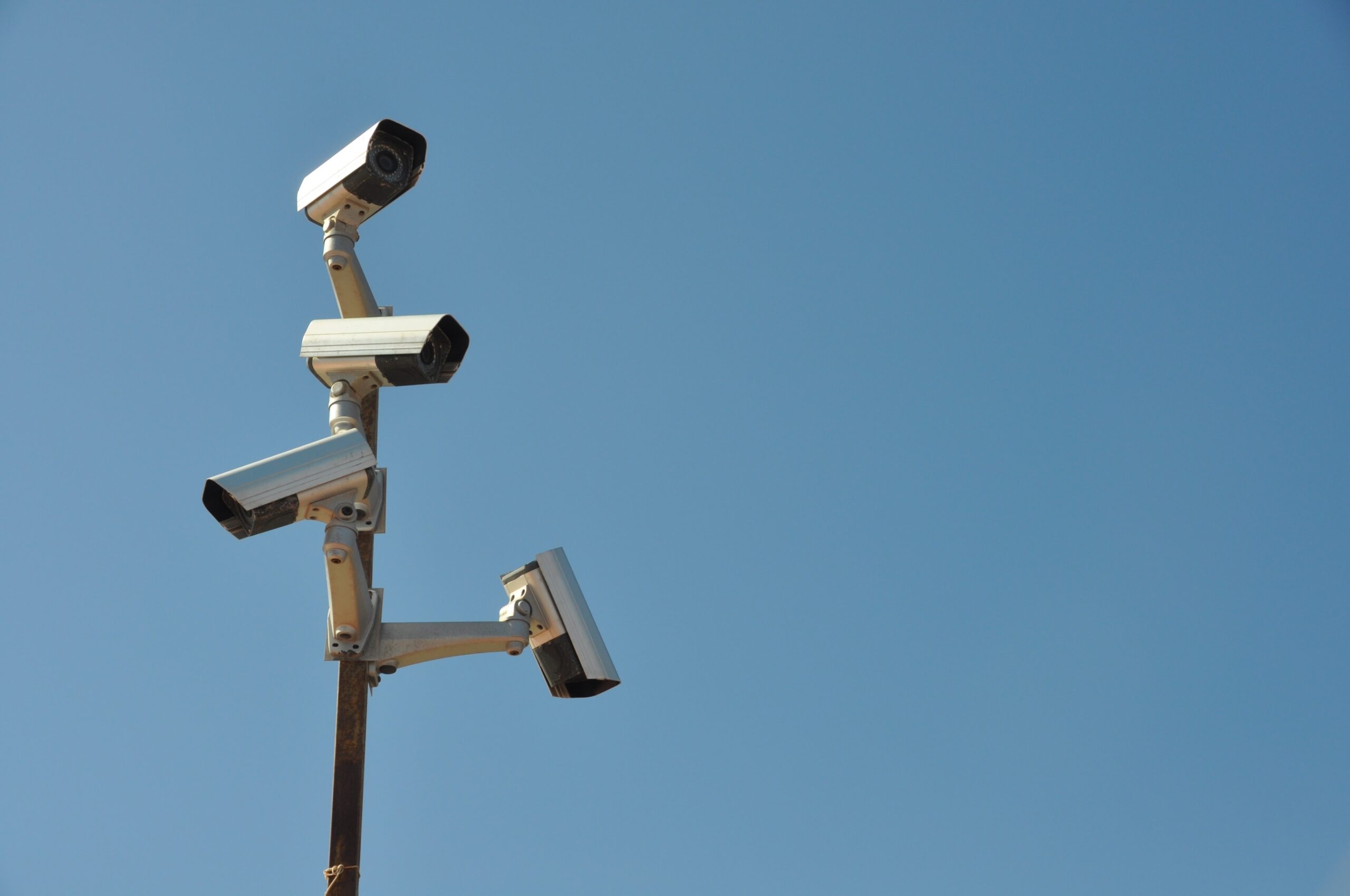 Surveillance camera on a post, during a sunny day