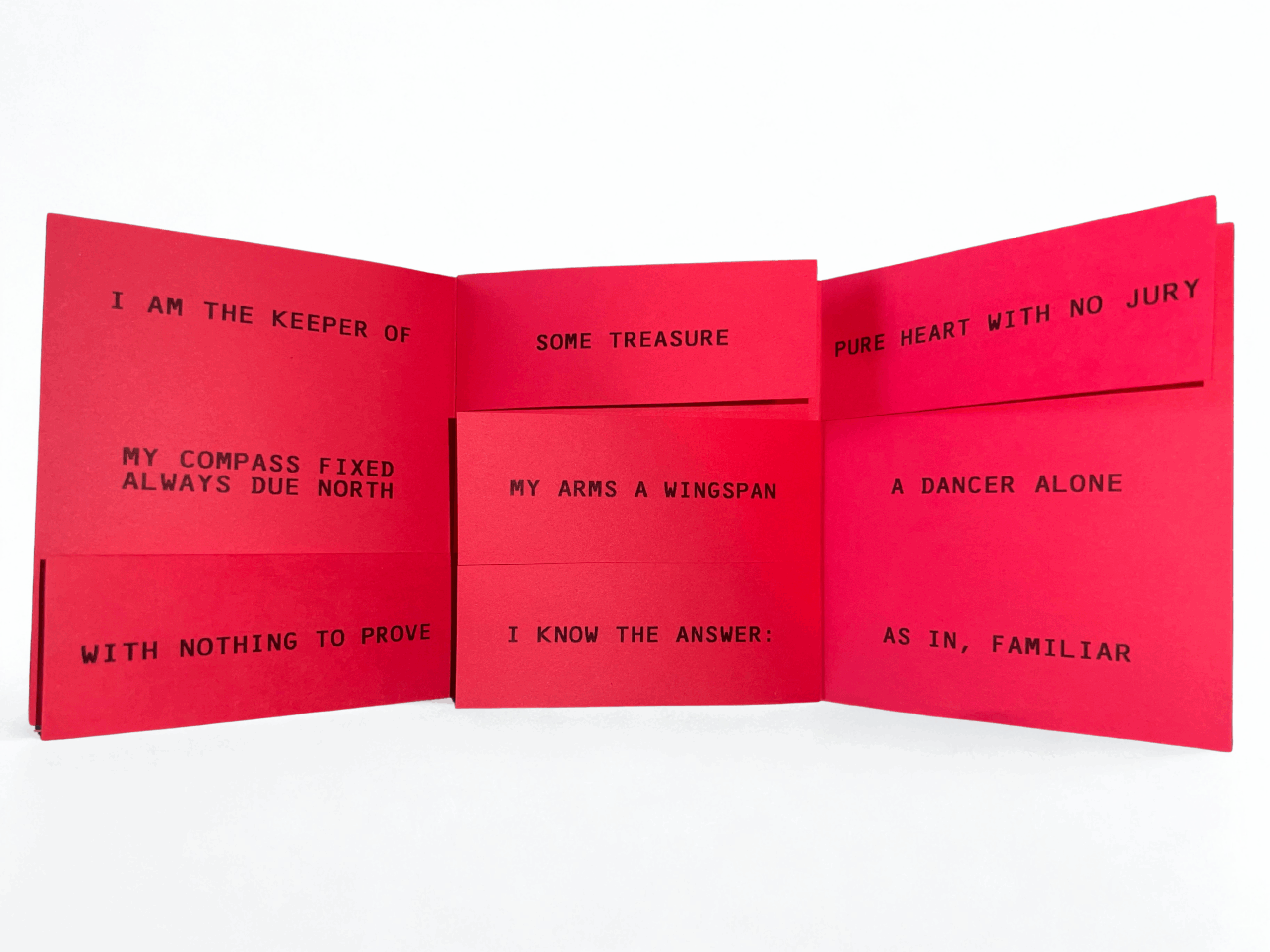 Accordion-style artist book unfolded against a white background, printed on vivid red paper with black uppercase text across multiple panels reading phrases including “I AM THE KEEPER OF,” “SOME TREASURE,” “PURE HEART WITH NO JURY,” and “MY COMPASS FIXED ALWAYS DUE NORTH,” emphasizing poetic fragments arranged across the folds.