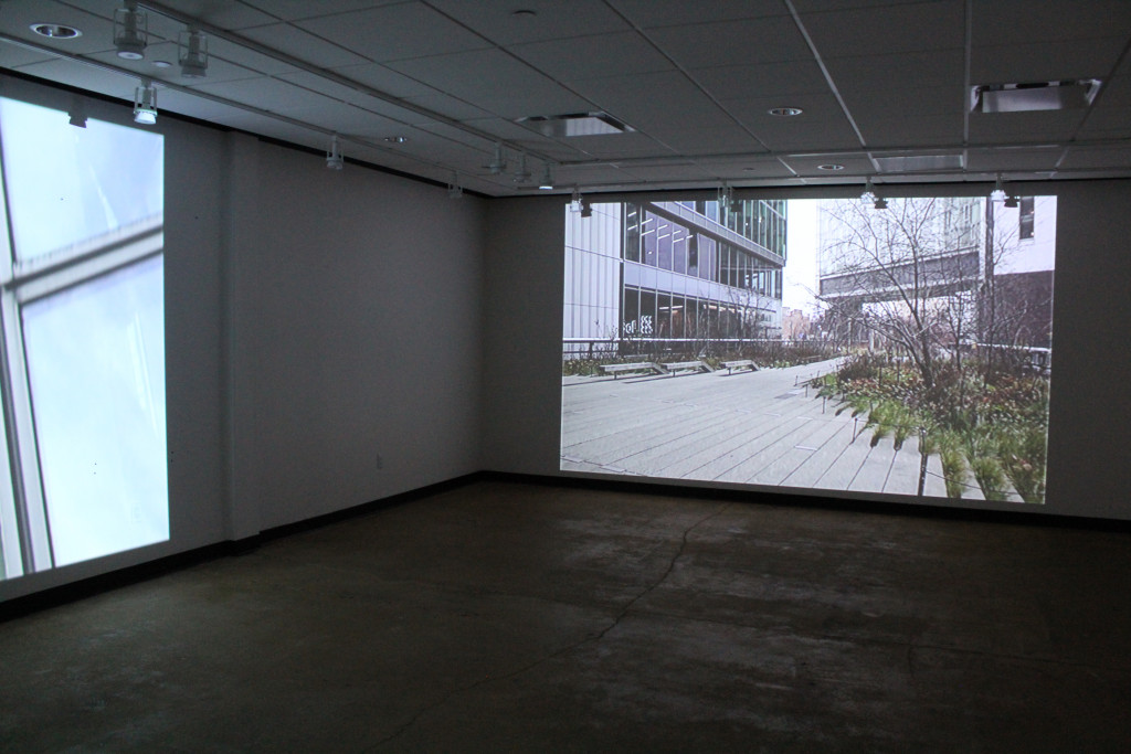 dark room with movie projection, depicting urban building and entrance stairs, with trees on the sidewalk leading up to the building