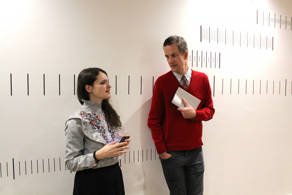 two students speaking in a gallery