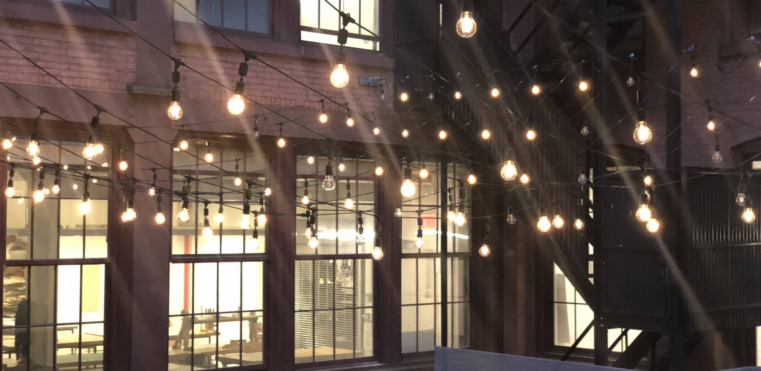 string lights hanging in a courtyard