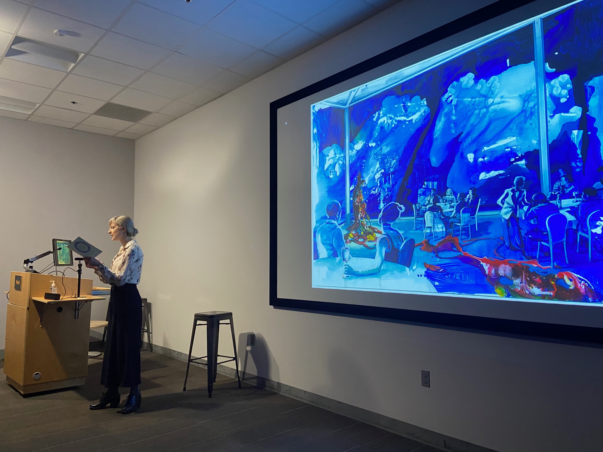 a woman giving a talk using a powerpoint presentation