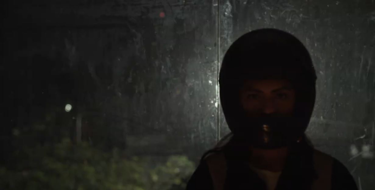 dark figure in front of a window at night