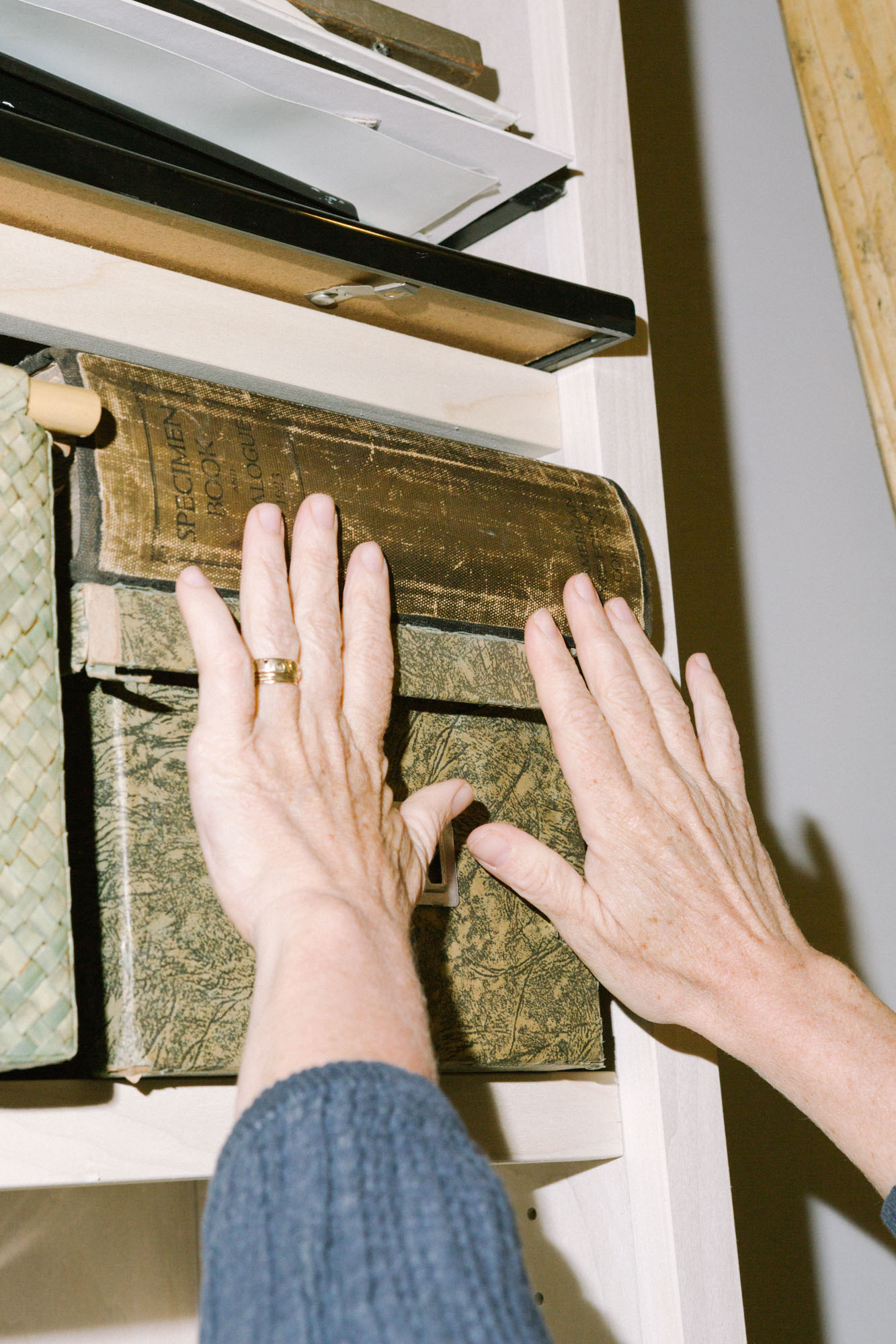 Hands reach for a thick vintage book