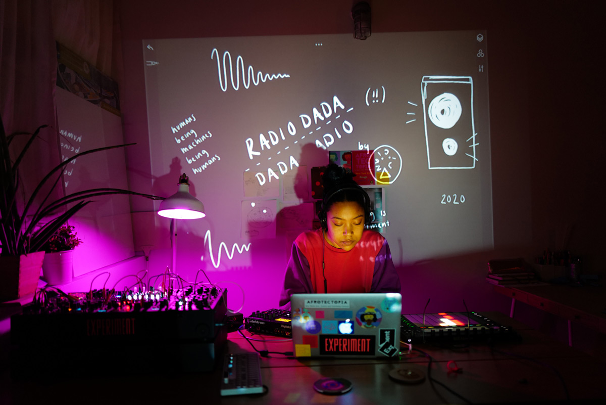 Picture of a girl on her laptop with a projection projected at her