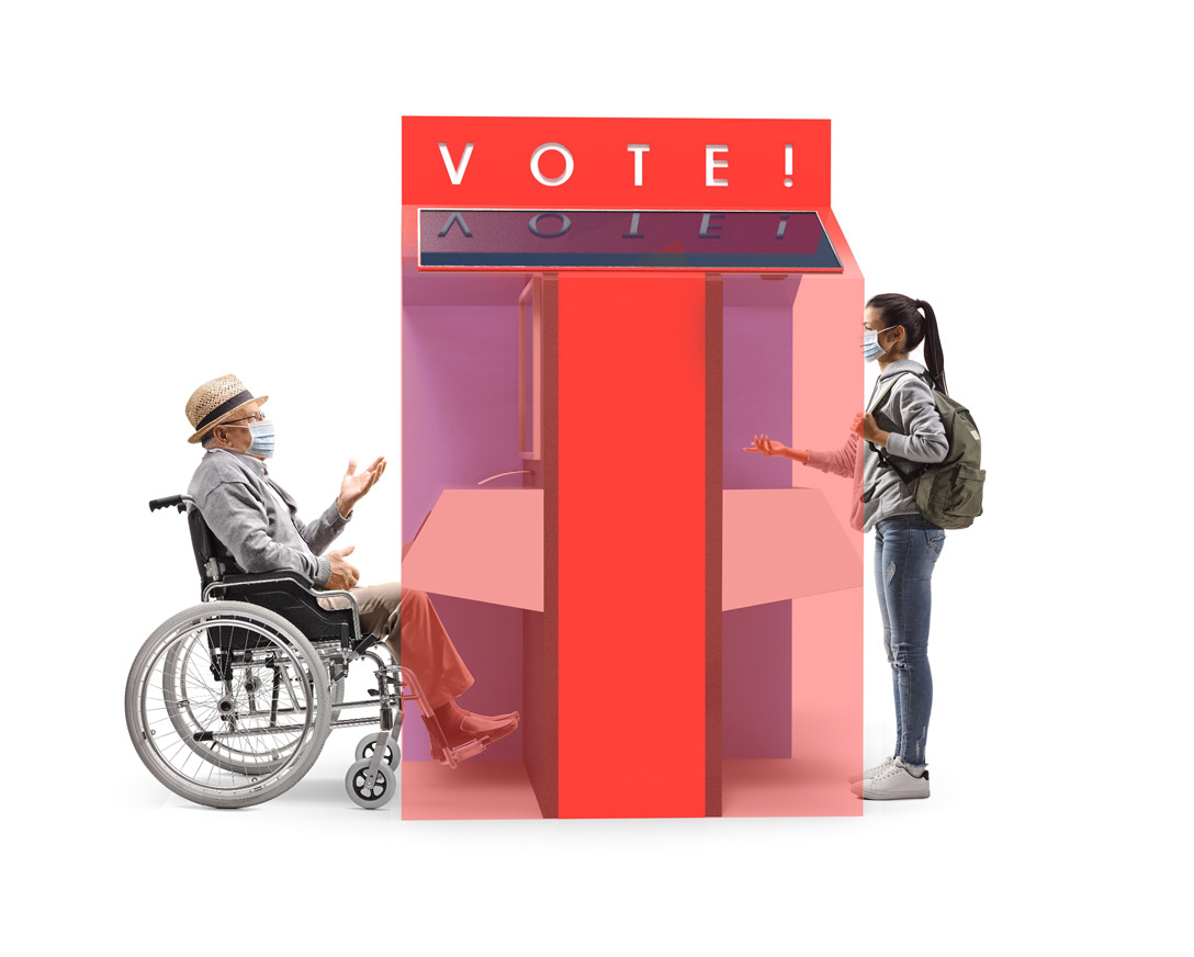 A person on a wheelchair and a standing person, voting on the separate ends of the voting booth.