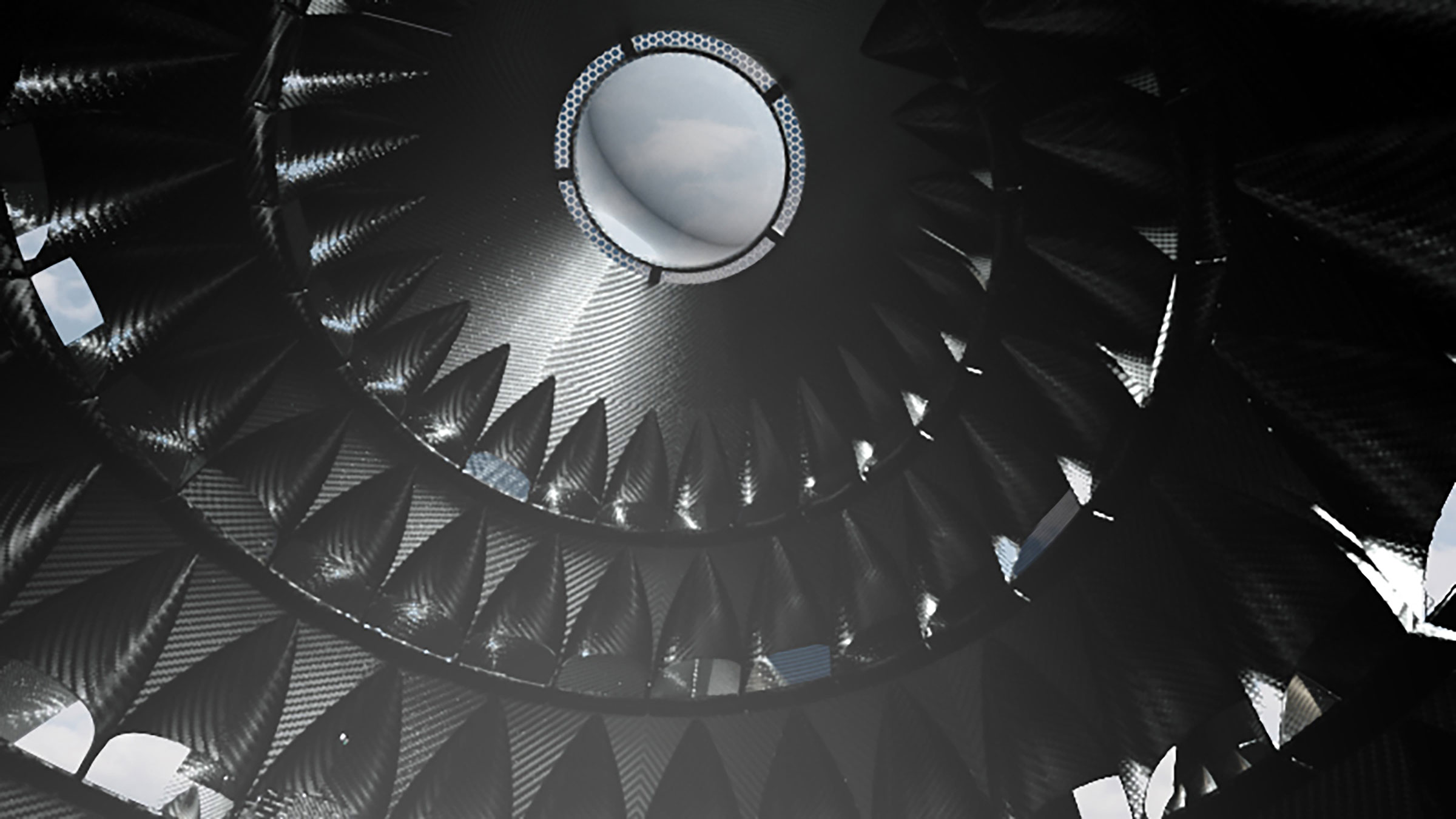 Interior of the black, ridged walls of a conical structure rising into a circular skylight with view of wintry gray-blue sky and clouds