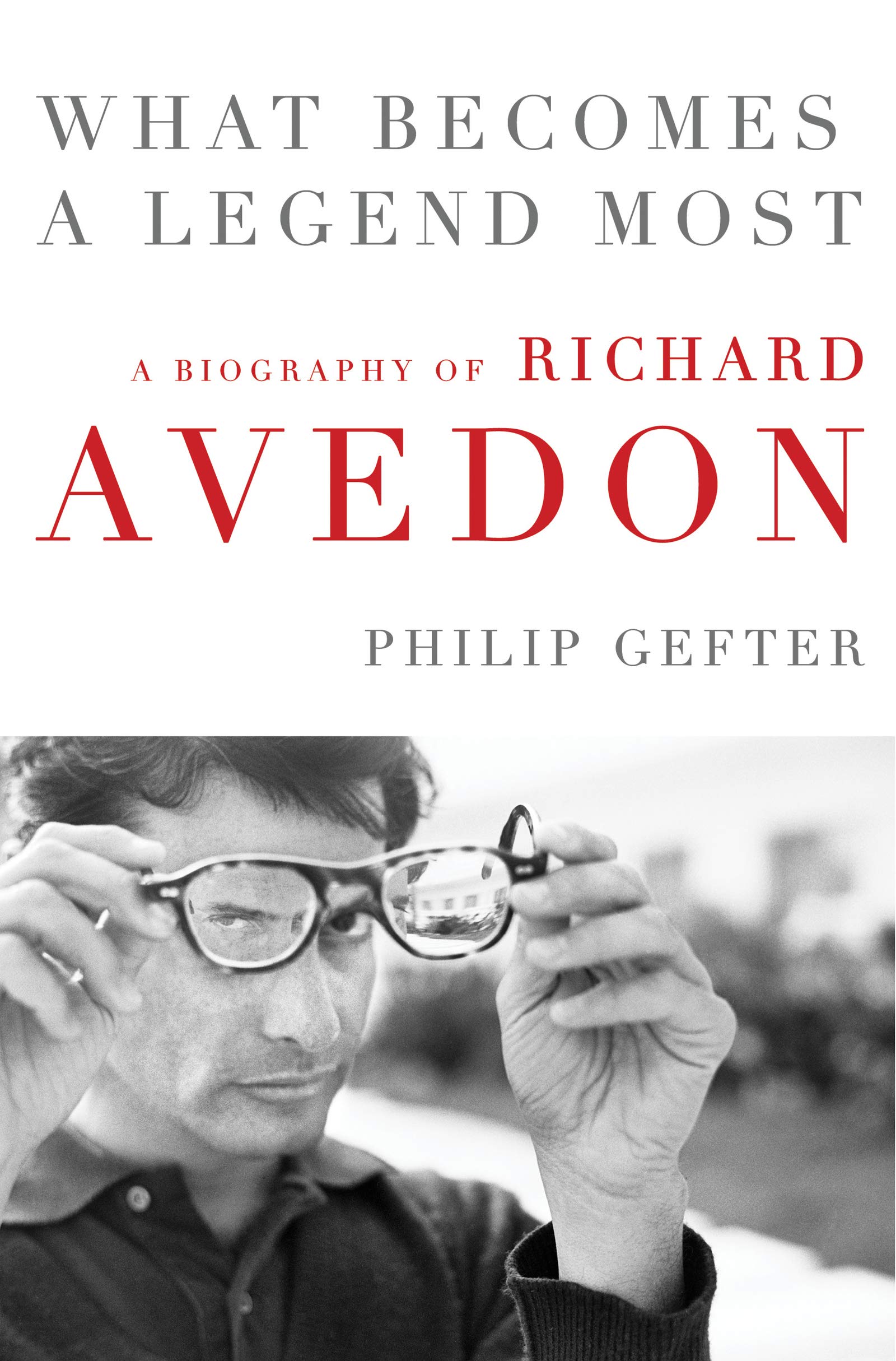 Cover of What Becomes a Legend Most, with Richard Avedon looking through tortoiseshell glasses held at arm’s length.