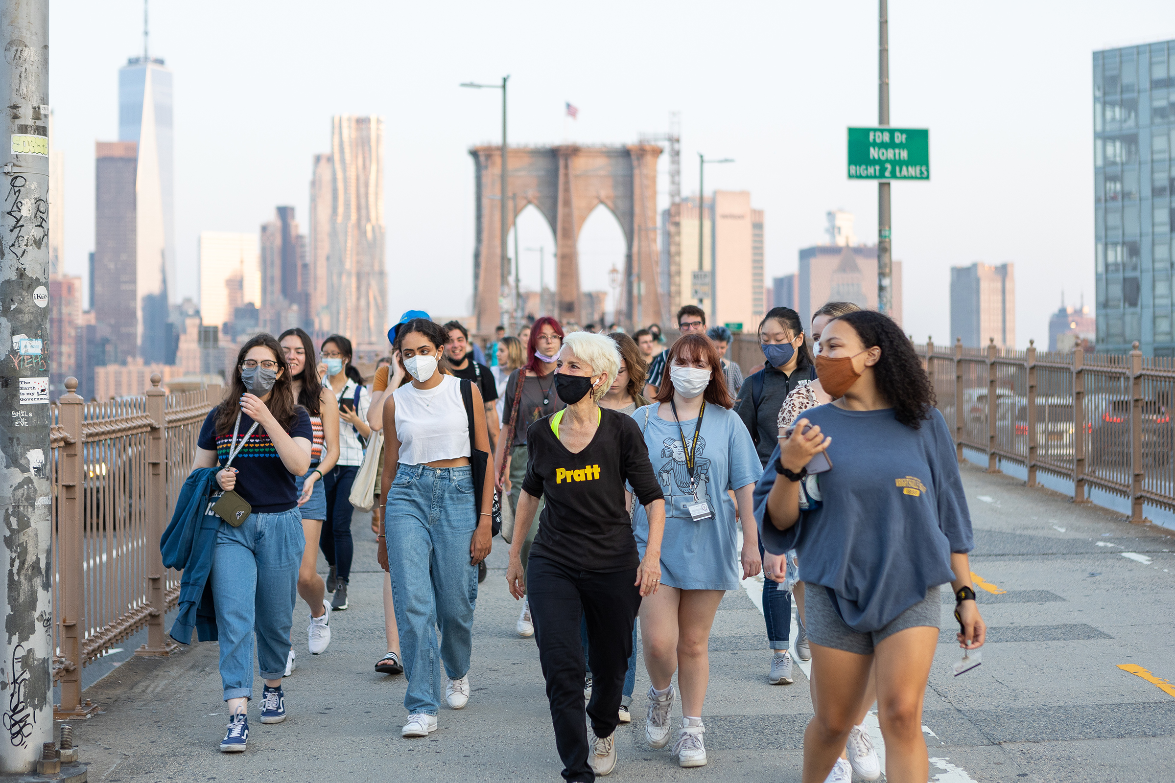 President Frances Bronet leading students over the Brooklyn Bridge (photo by Sam Stuart Hollenshead)