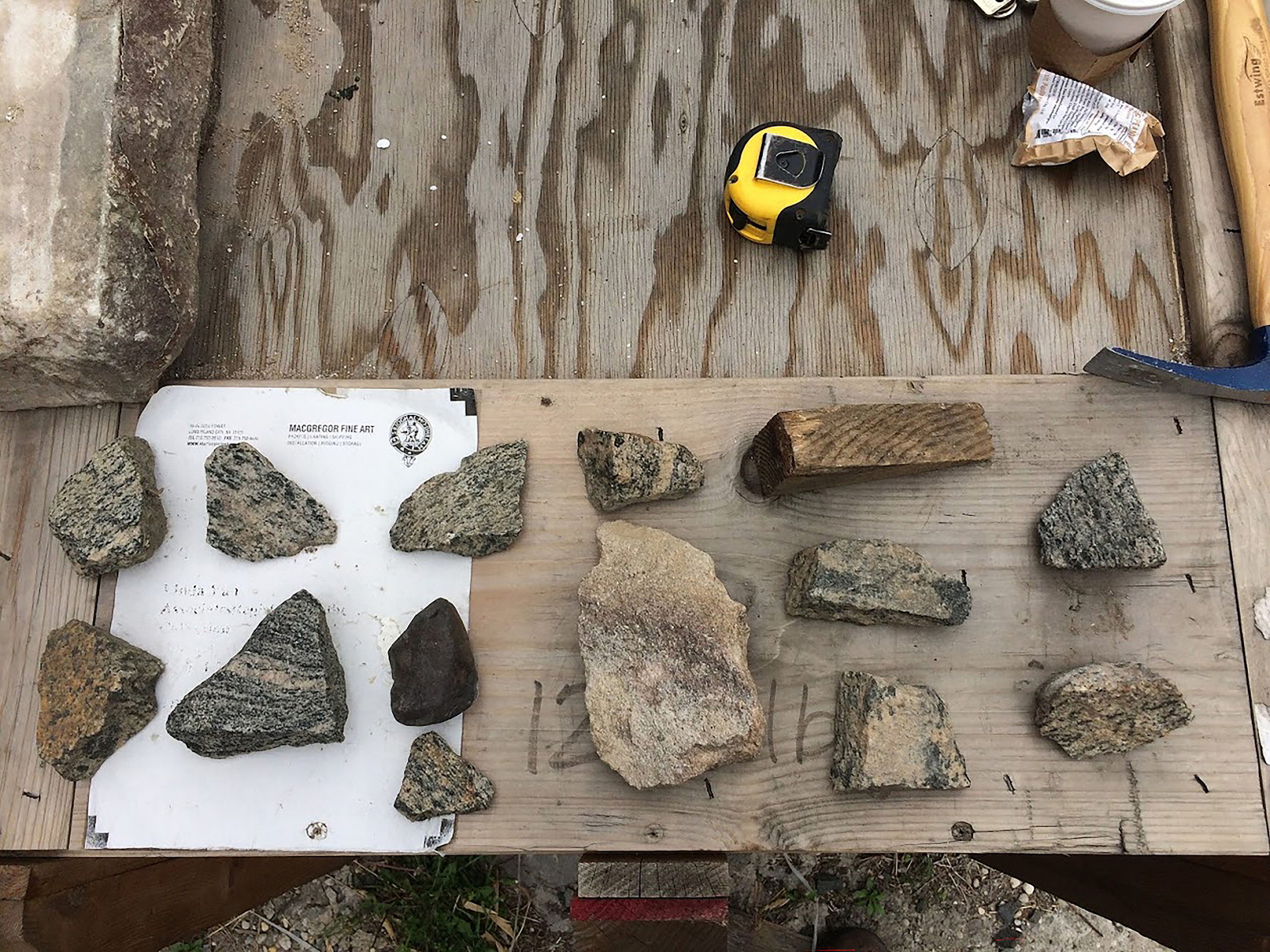 Various rocks displayed on a wooden board