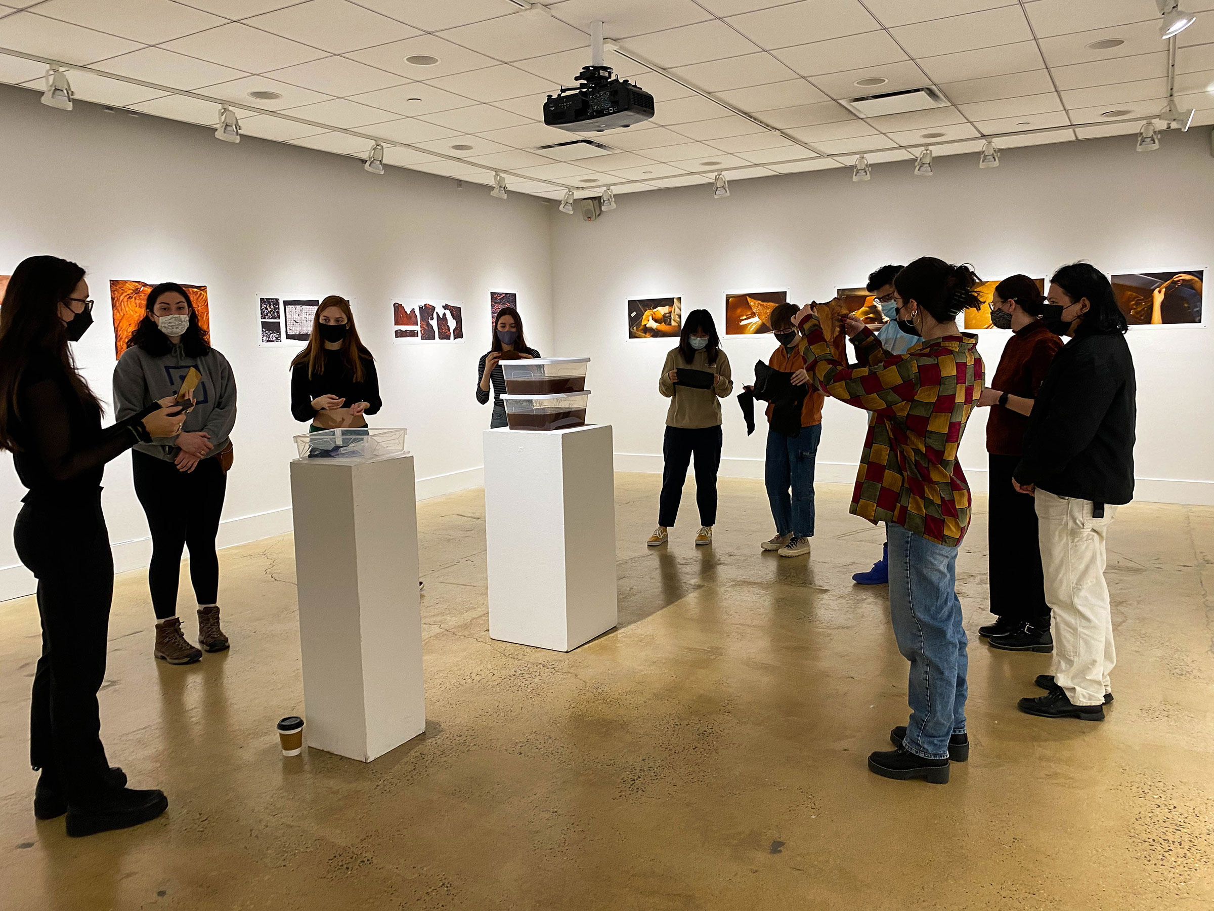 Madison Wilds Burger, at far left, sharing her work with current Pratt students