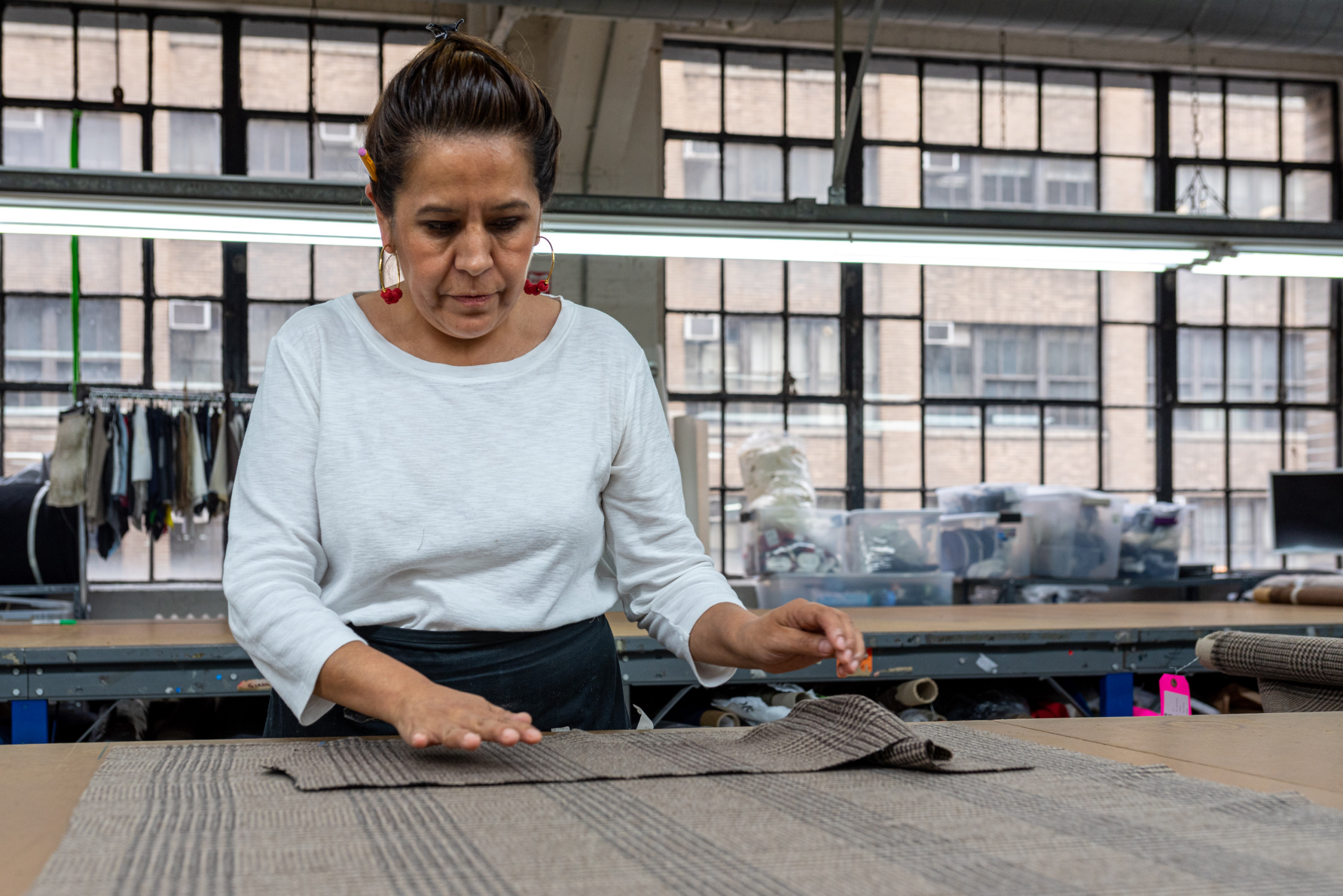 Garment maker lays out pattern pieces on a work table