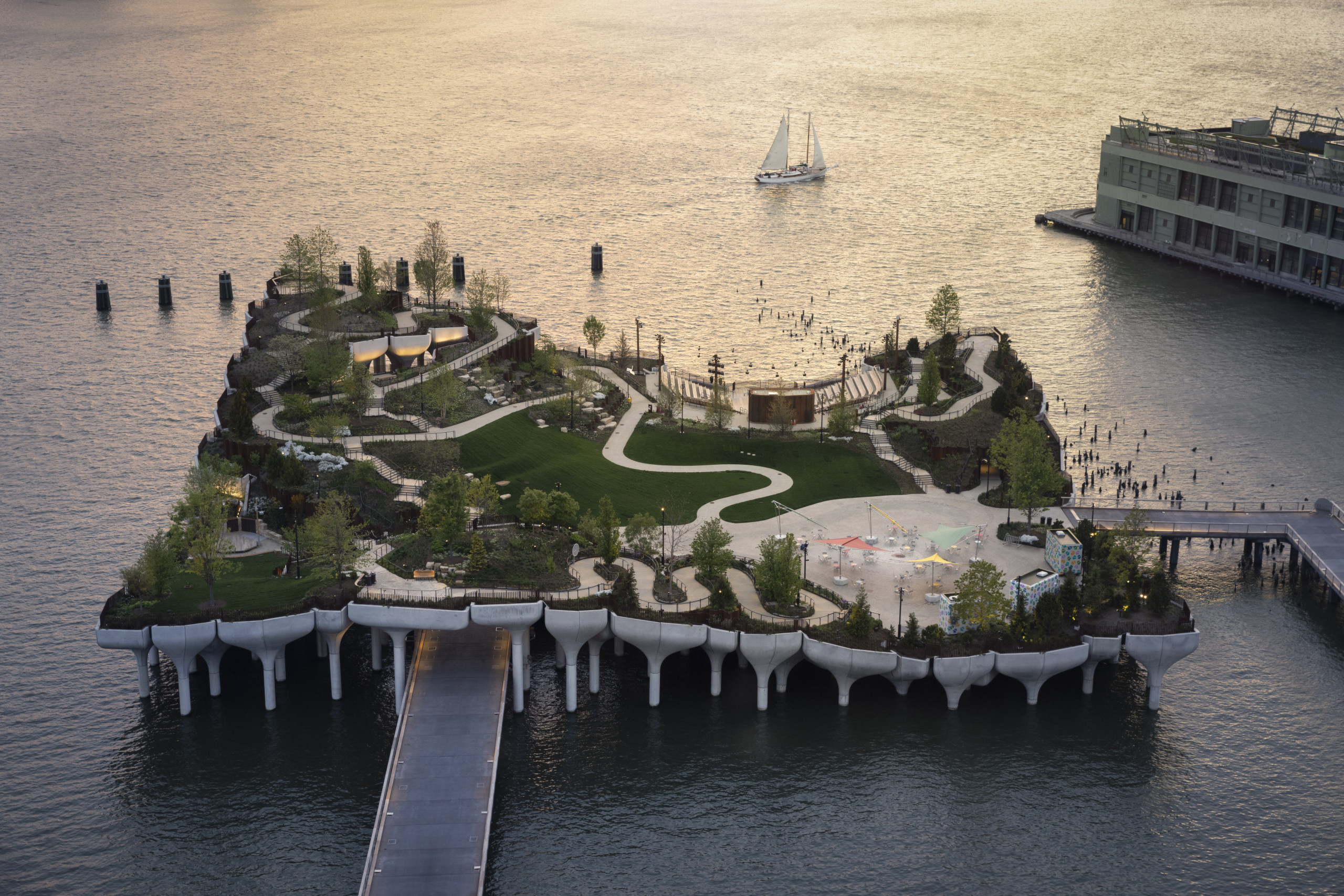 Aerial view of Little Island at twilight showing winding paths and undulations of pier over the water