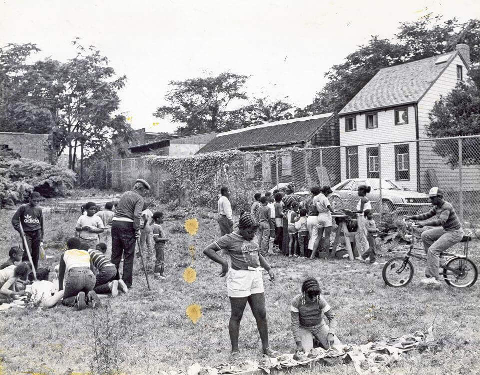 People of all ages exploring the site of former homes on Hunterfly Road in Weeksville circa 1970