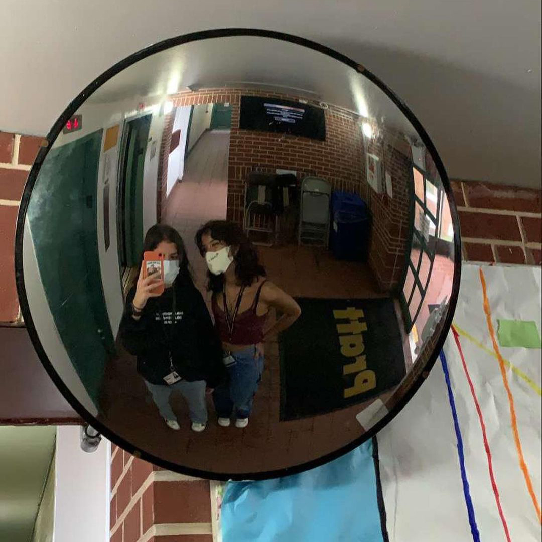 Students take a selfie in a convex mirror