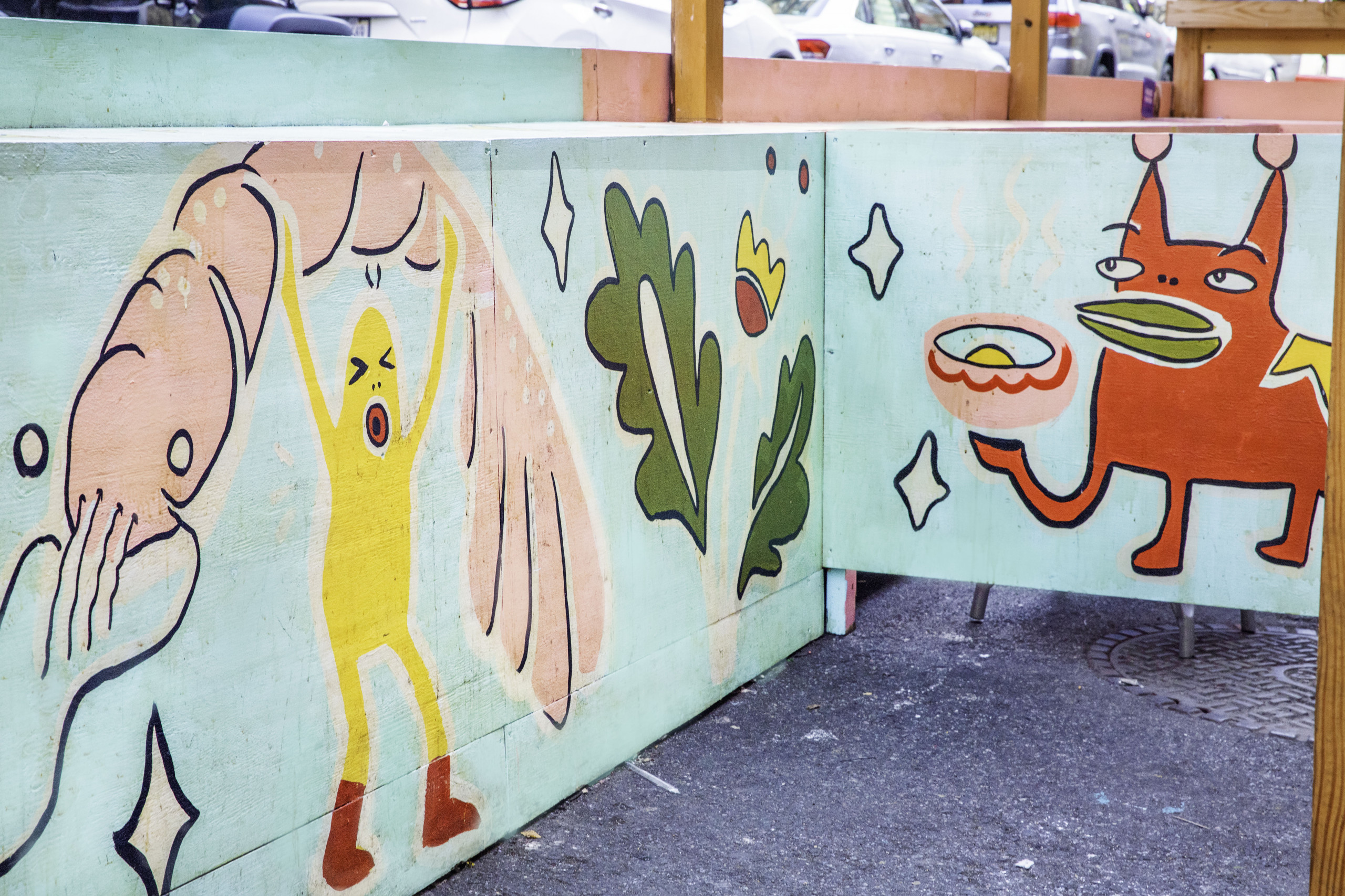 Playful illustrations of cartoon animals and food on dining structure walls