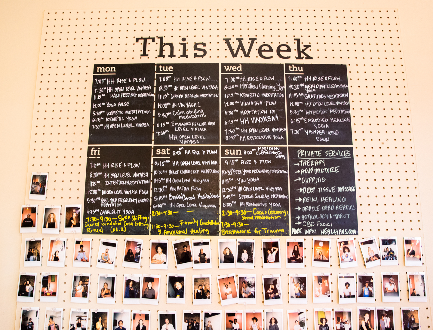 Blackboards with schedule of daily activities at HealHaus above photos of community members