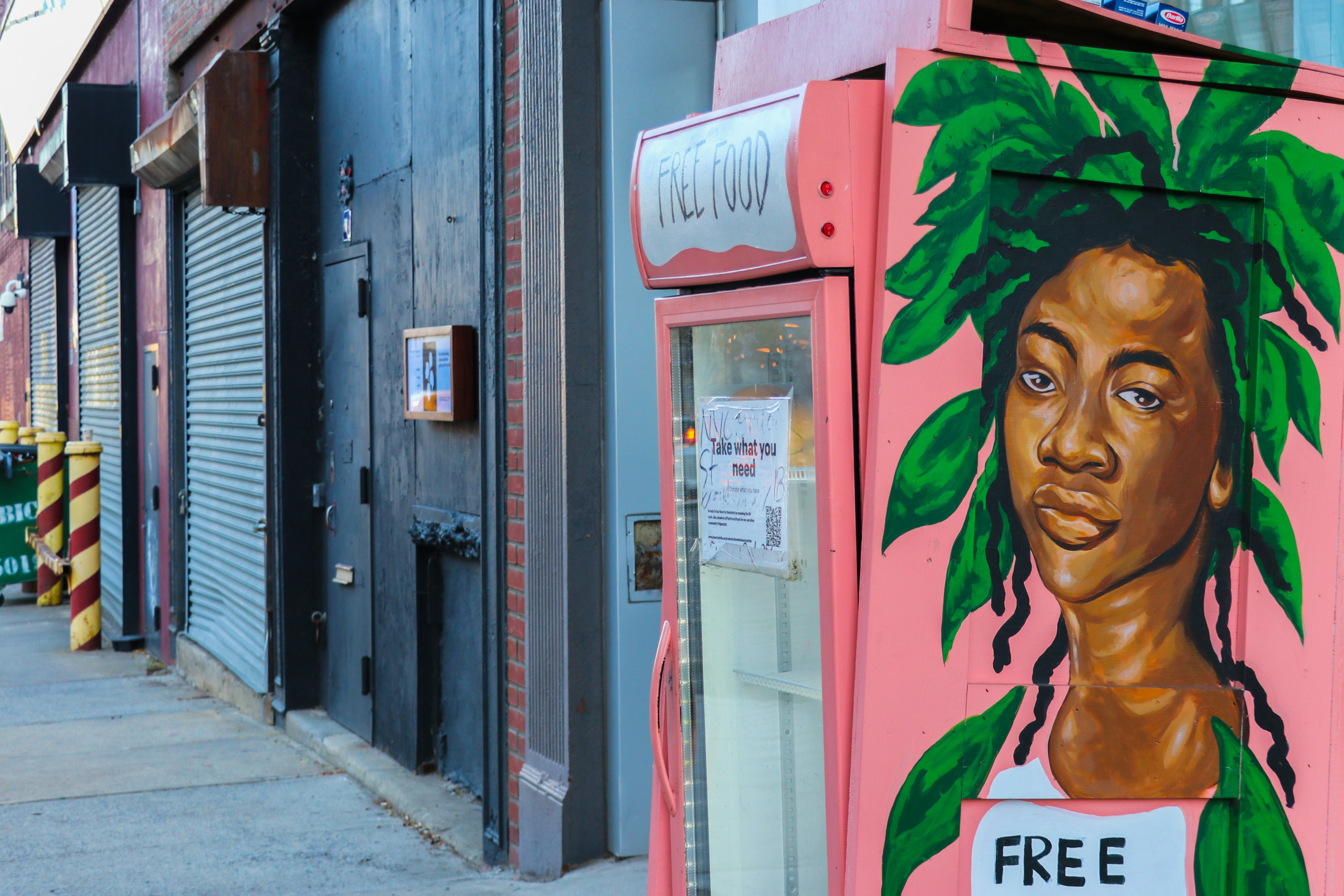 Pink street-fridge structure with portrait of a Black youth crowned in bright green leaves