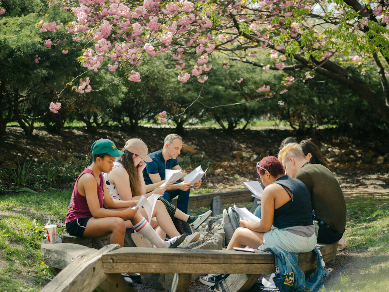 students gathered around a picnic table, on campus
