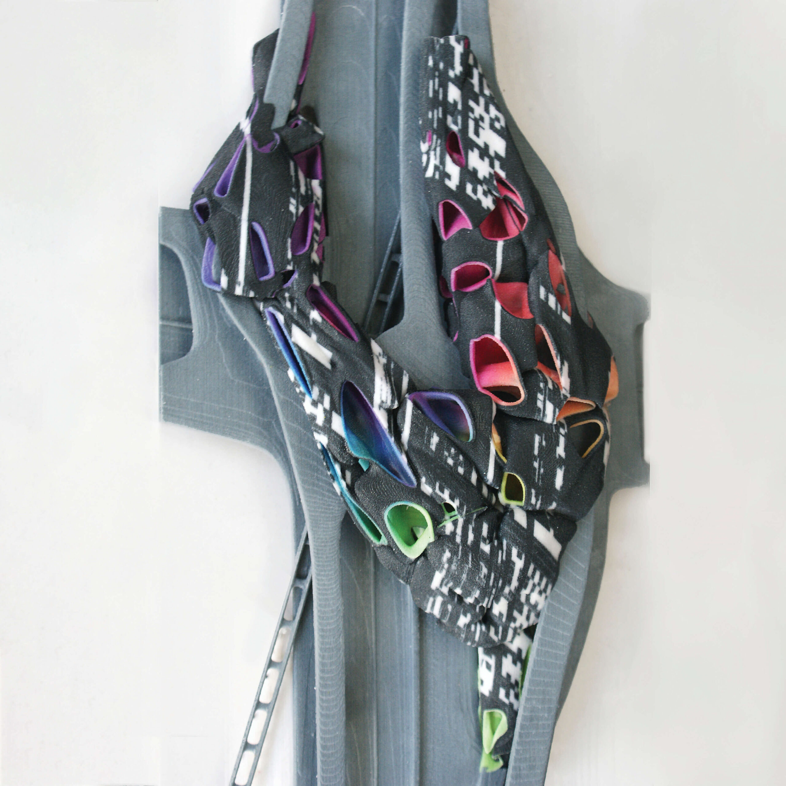 A top down image of a grey, abstract 3D-printed architectural model. It is set on a white background.