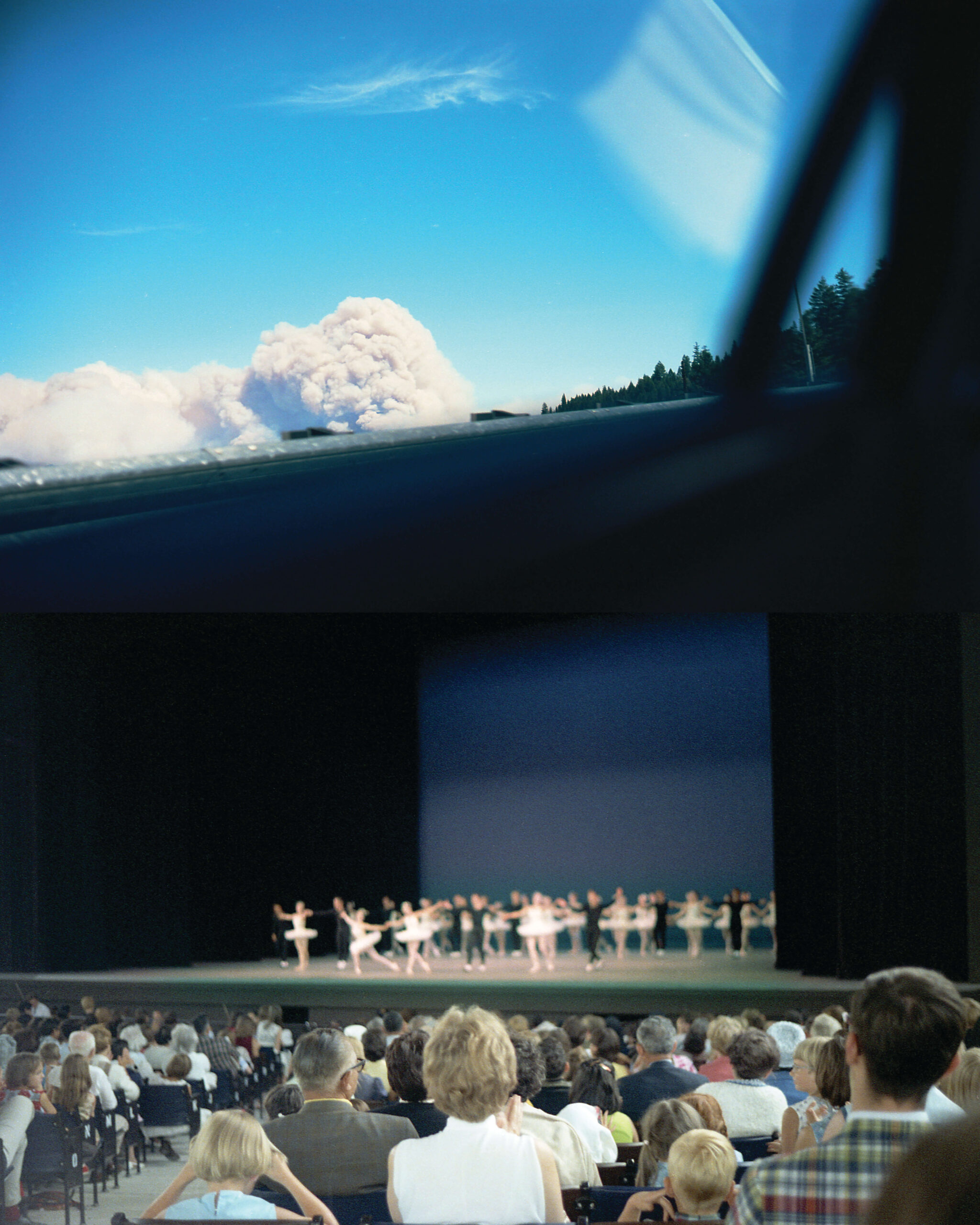 A phot of an auditorium with an open ceiling. There a ballet performance on stage and a large crowd looking in awe.