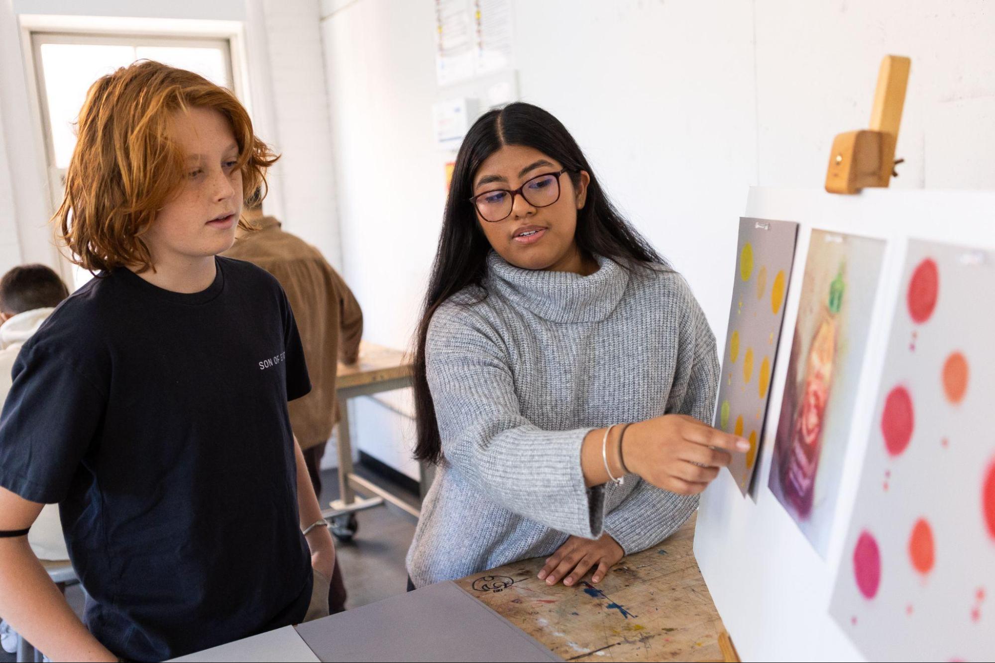 Student-teacher working with a middle school student.