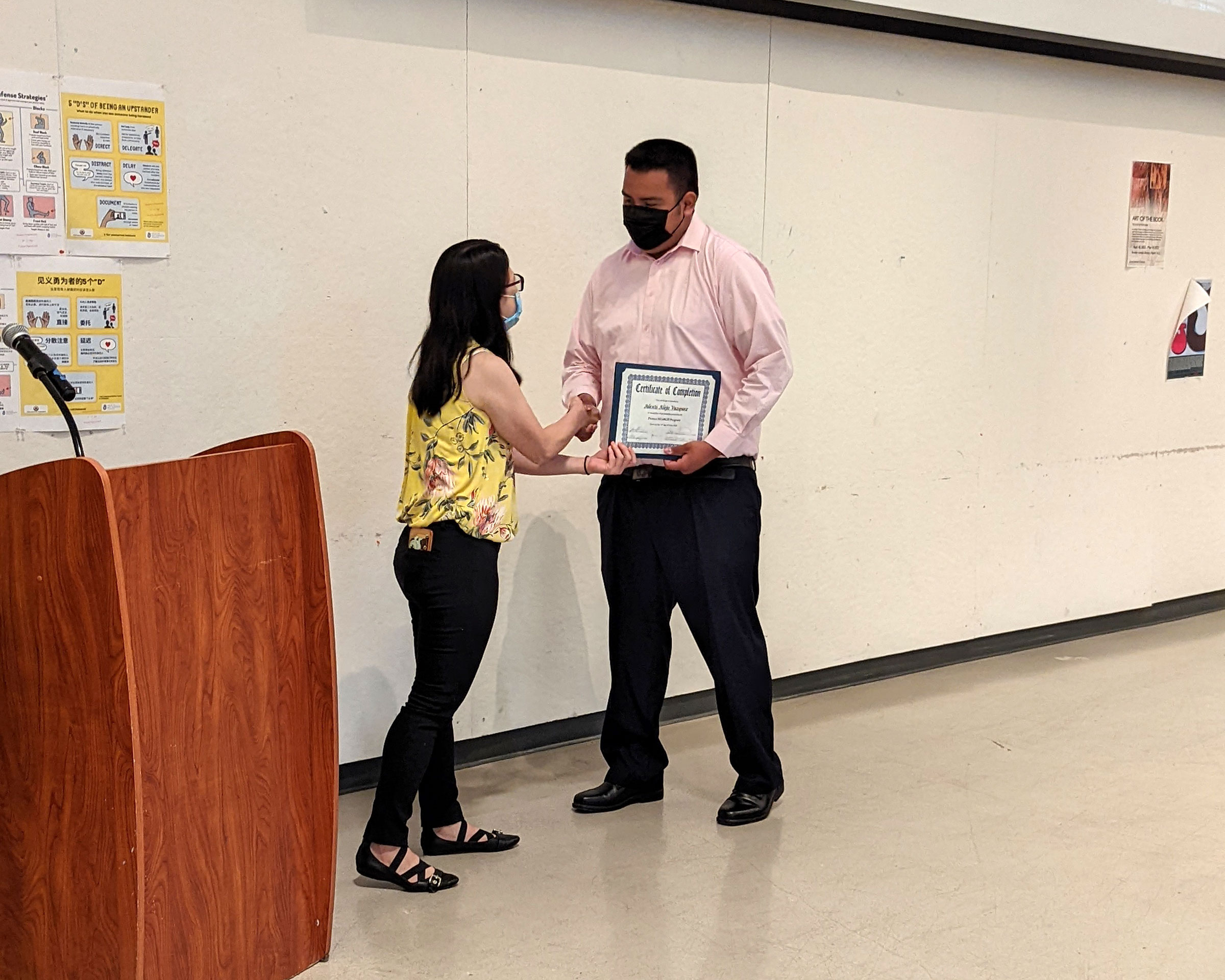 Alexis Alejo Vazquez receives a Certificate of Completion at the graduation celebration.