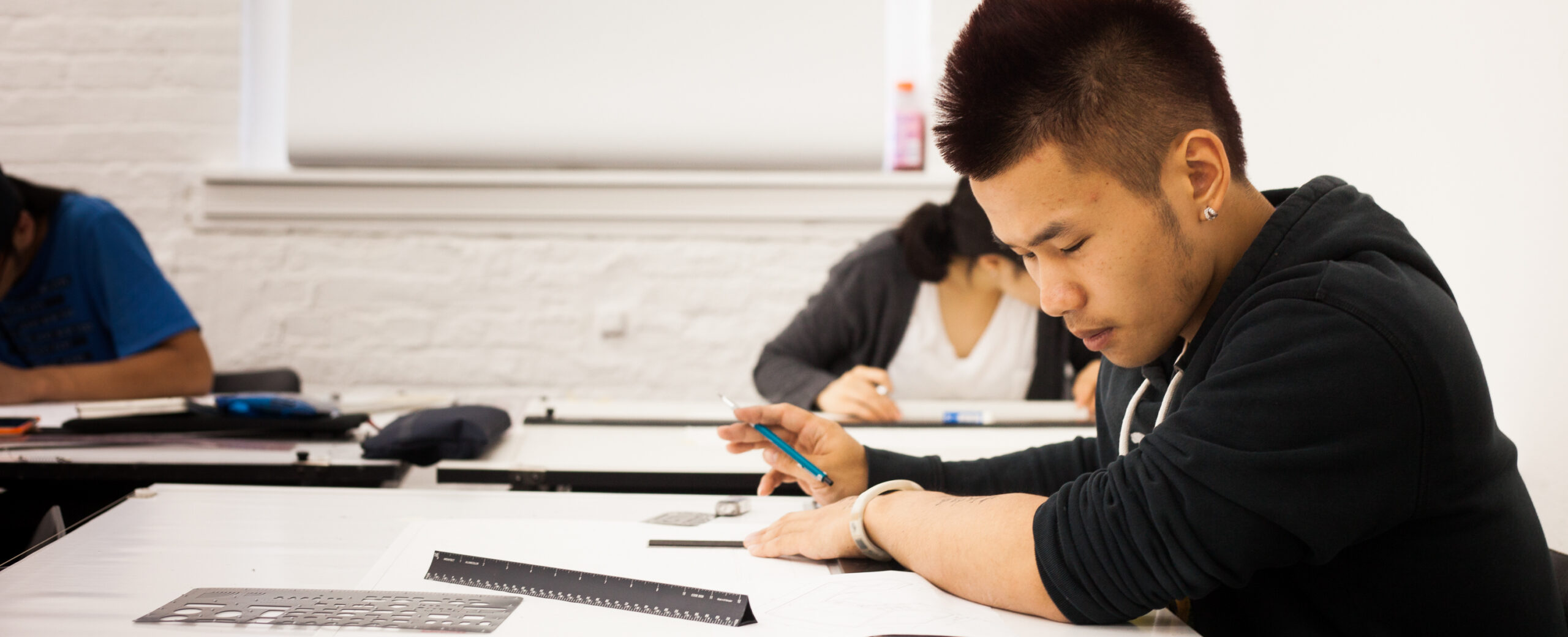 A student works at a desk.