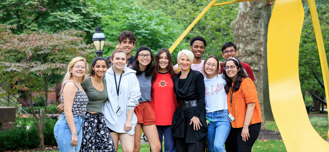 a group of students poses with President Frances Bronet