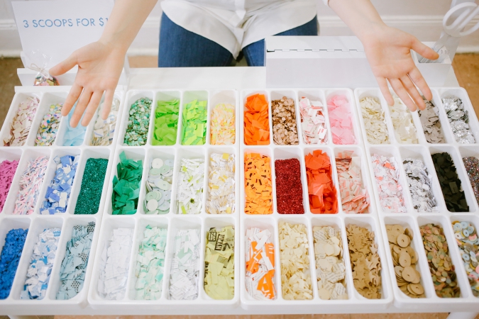 A box filled with colorful arts and craft bits of material