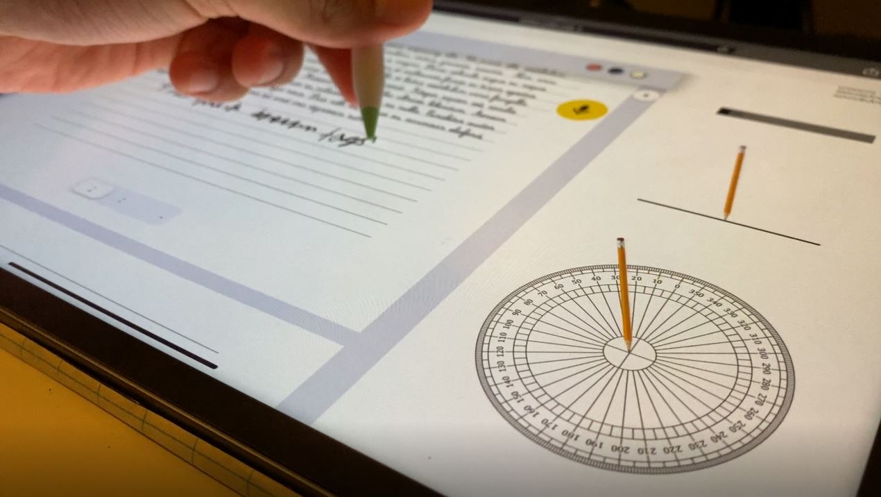Image of hand writing on the left side of the screen, with circle and analysis of pencil pressure and angle on the right.