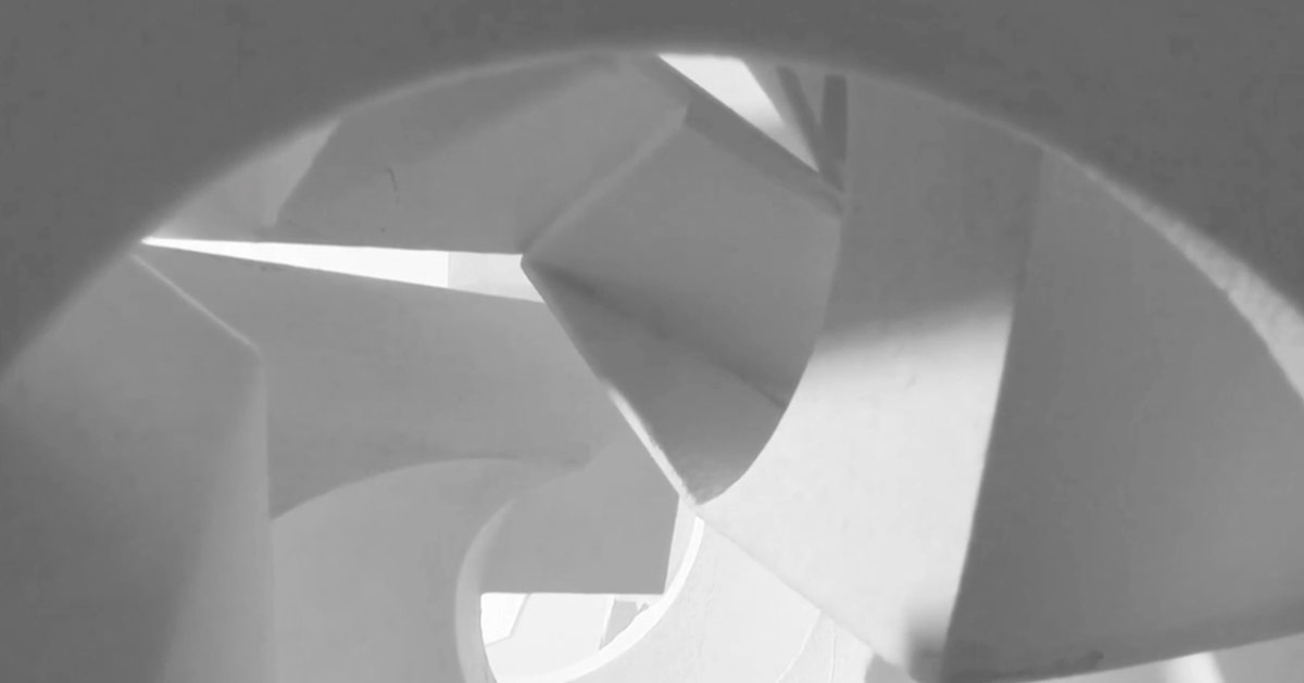 An abstract view of a structure with curved and fragmented surfaces