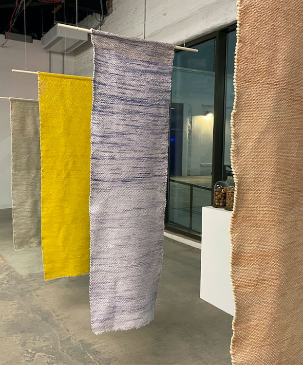four hanging tapestries in multiple colors