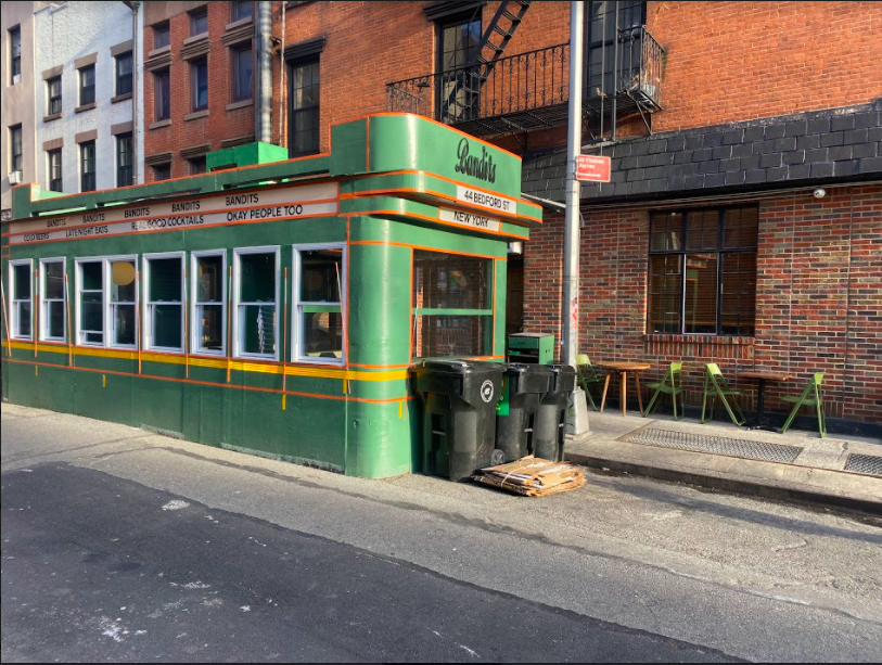 closer view of the elevation of Bandits structure, in front of the storefront of the restaurant.