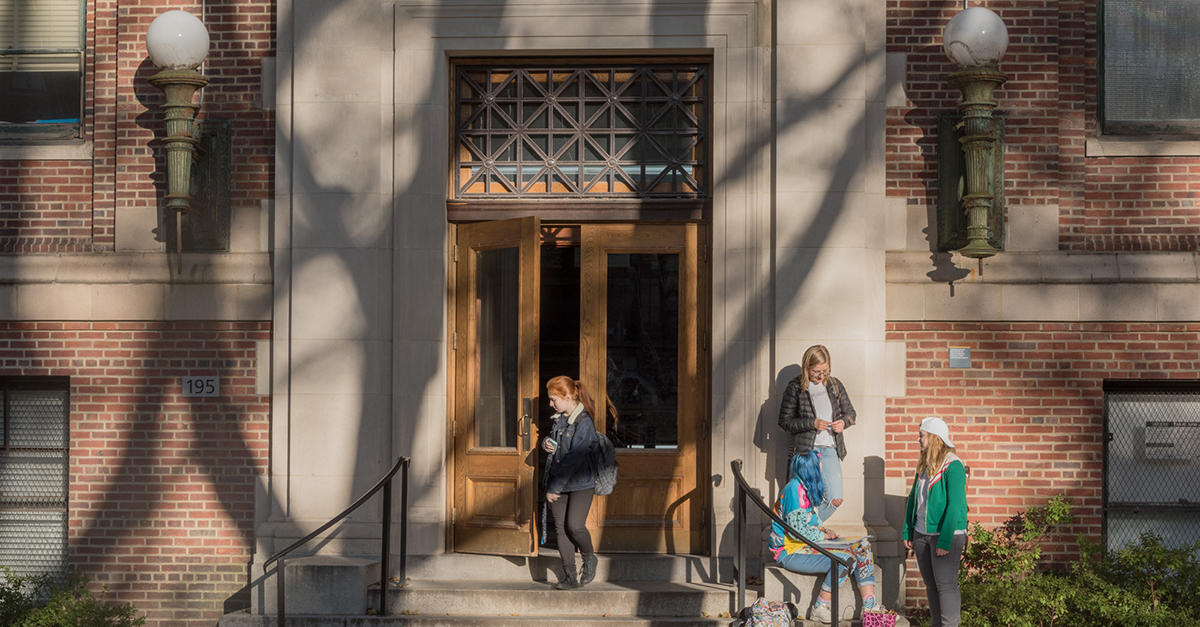 Front of a Pratt building, with students going in and out.