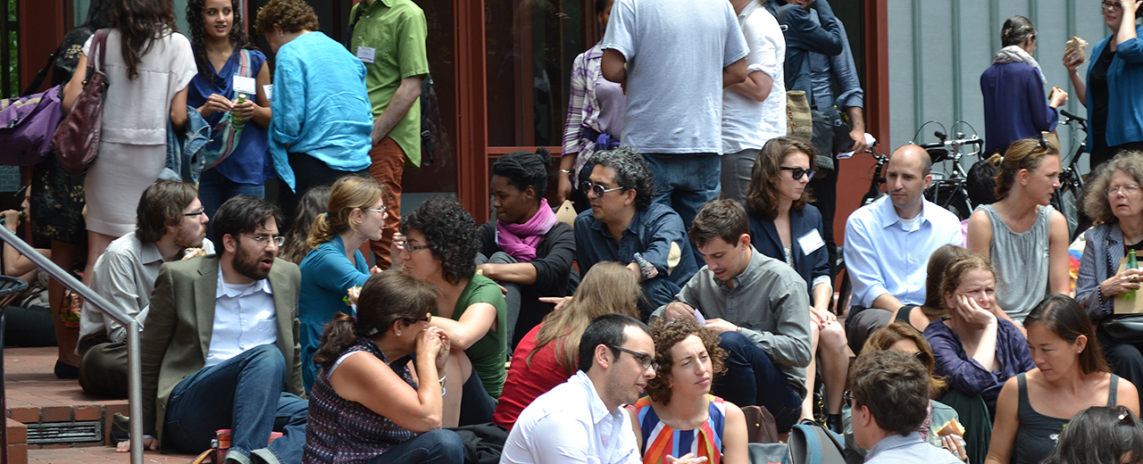 Faculty gather around during an event.