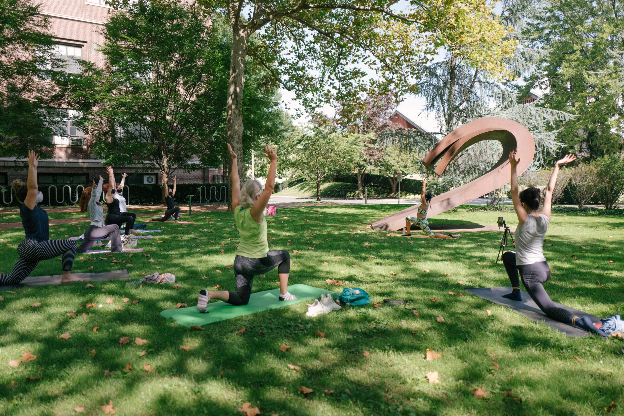 students seated and laying down on pratt lawn