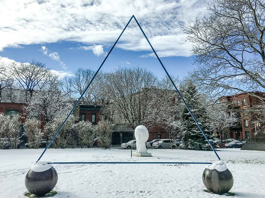 Leo Smith's Triangle. In minimal but lyrical terms, Smith has created a tenuous triangle delicately balanced on two metal balls. The triangle almost disappears in the landscape; it seems to float freely.