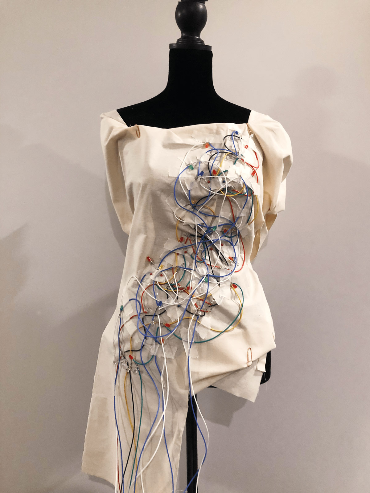 garment shows exposed wiring detail