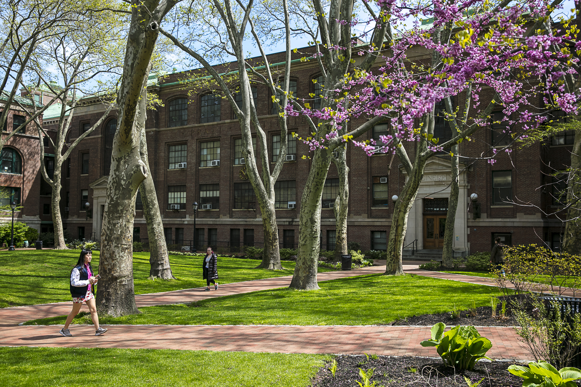 A woman walking on campus grounds