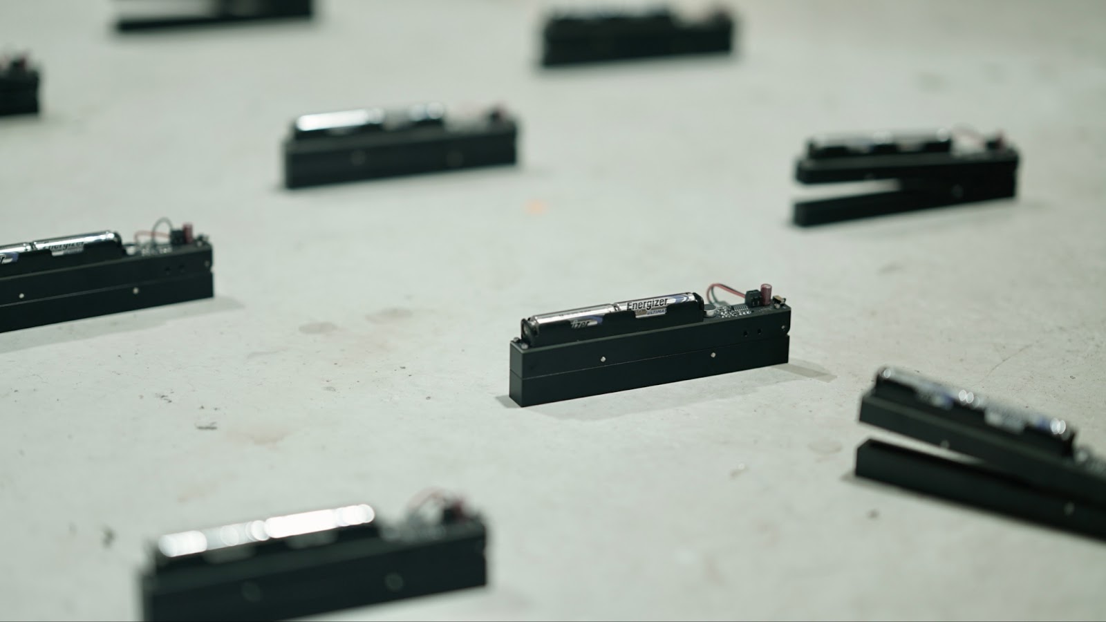 depiction of textured cylinders, multiple, on a grey surface