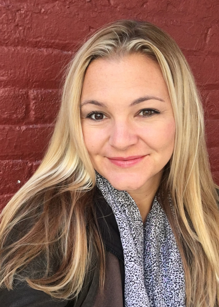 Headshot of designer Camille Murphy, smiling and looking into the camera